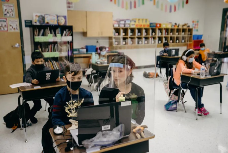 Student Kaison Hockenbarger and teacher Abigail Boyett go over his answers to a multiplication assignment in a Northside ISD classroom. Credit: Alejandra Casas for The Texas Tribune Tribune_pic_01-15-21_students-(1).jpg